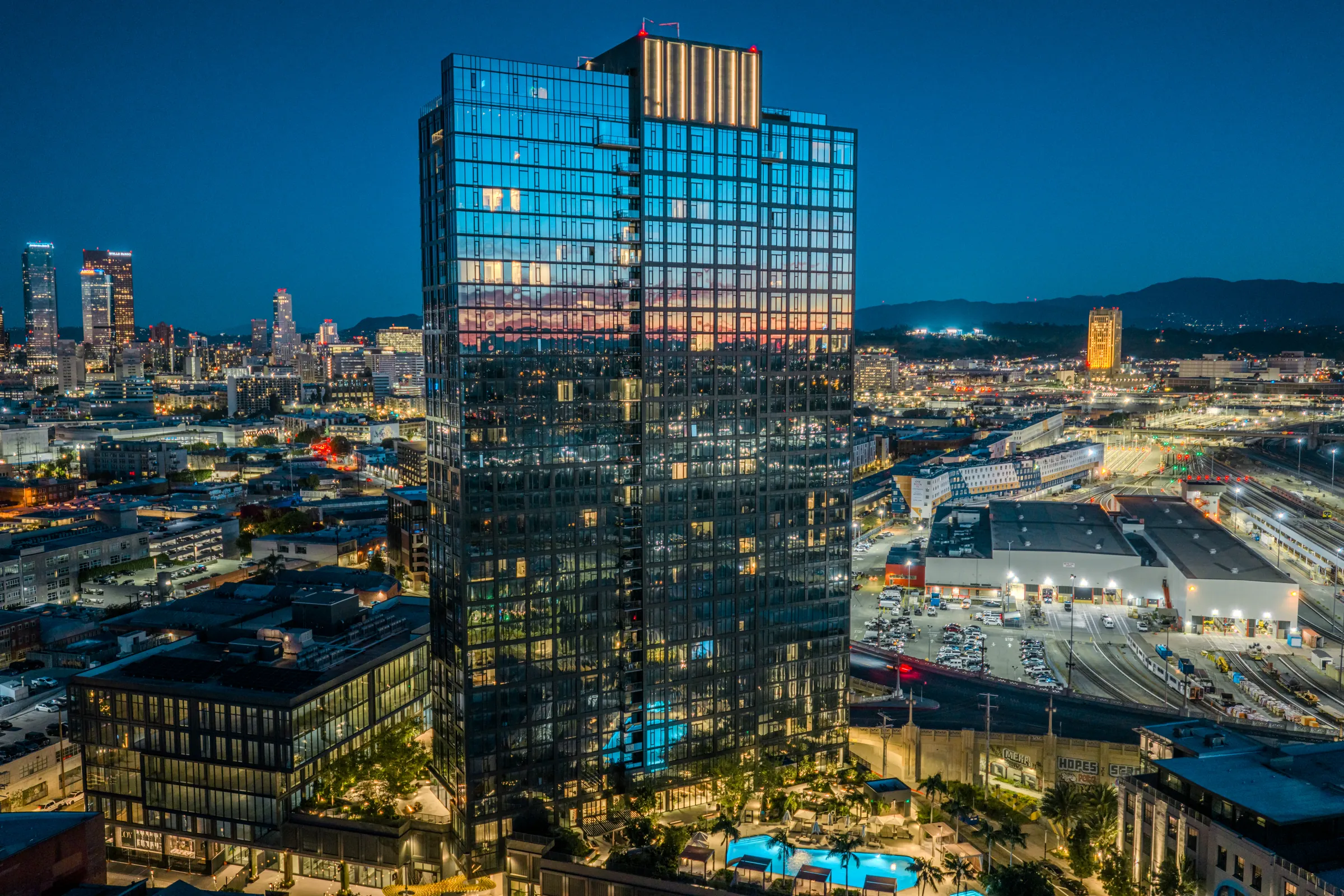 Aerial architectural photograph of the Alloy hotel tower and downtown skyline at blue hour