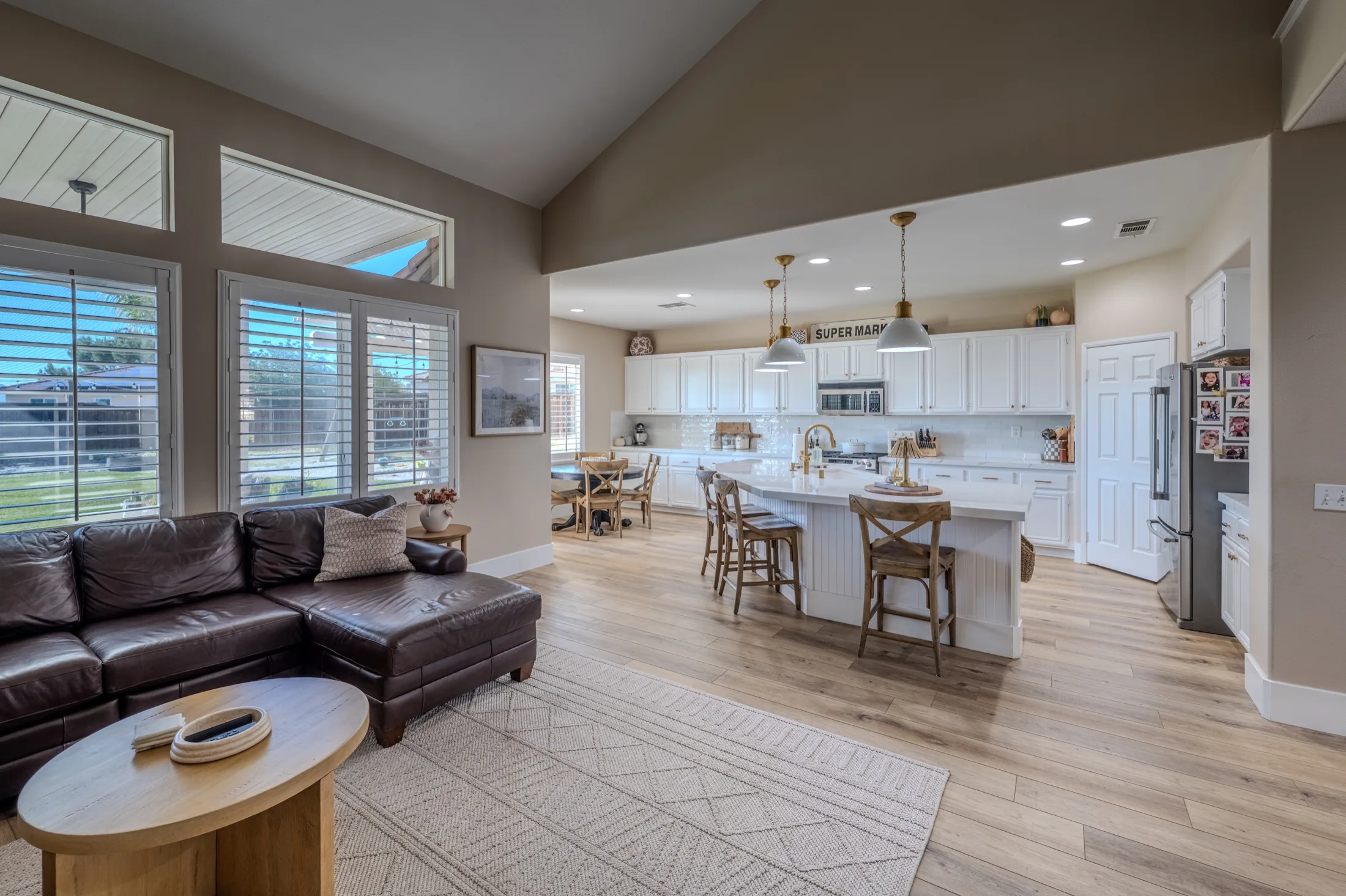 Open living and kitchen space showing the completed flooring installation