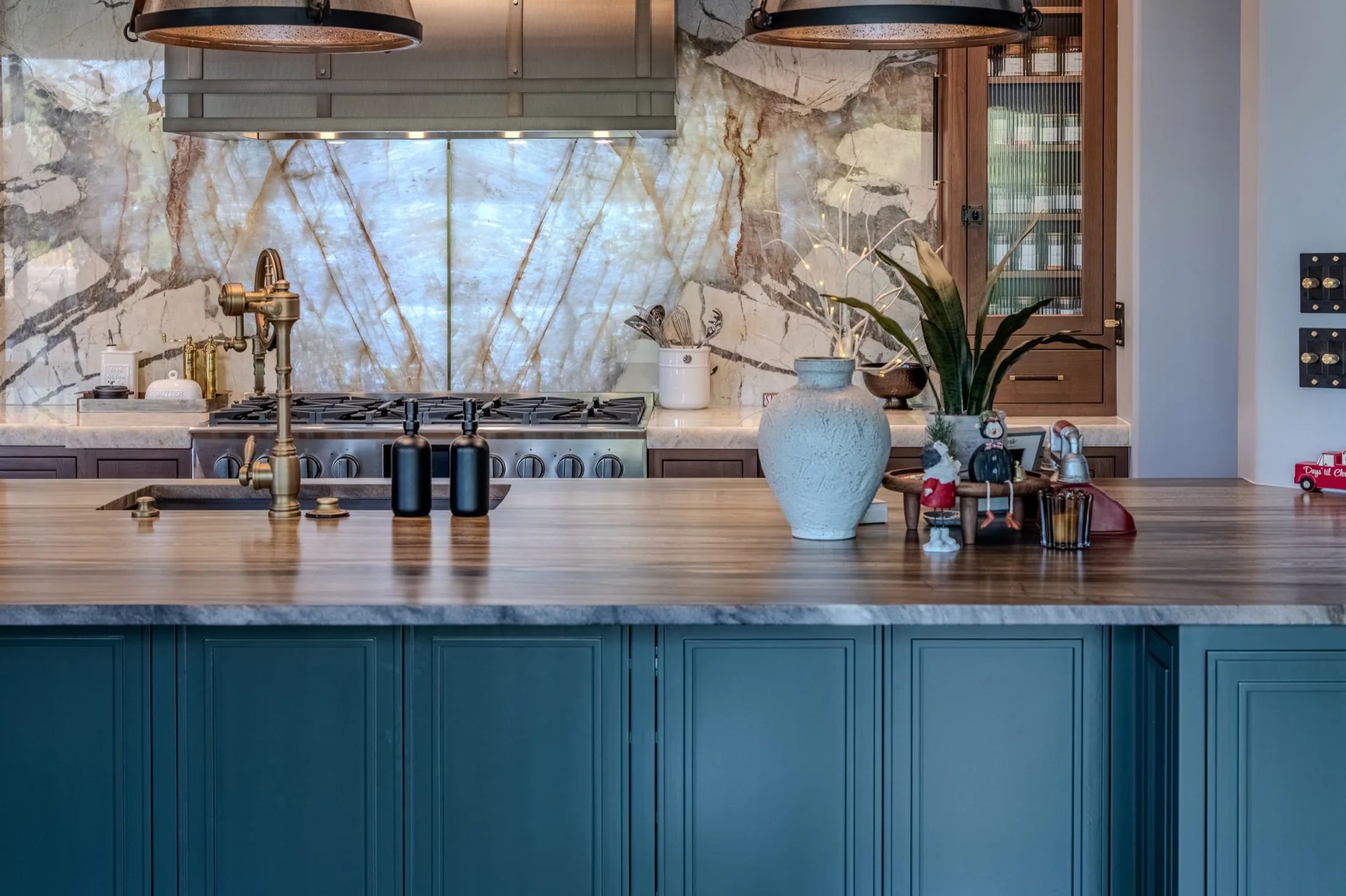 Pacific Stone kitchen remodel with statement stone surfaces and deep blue cabinetry