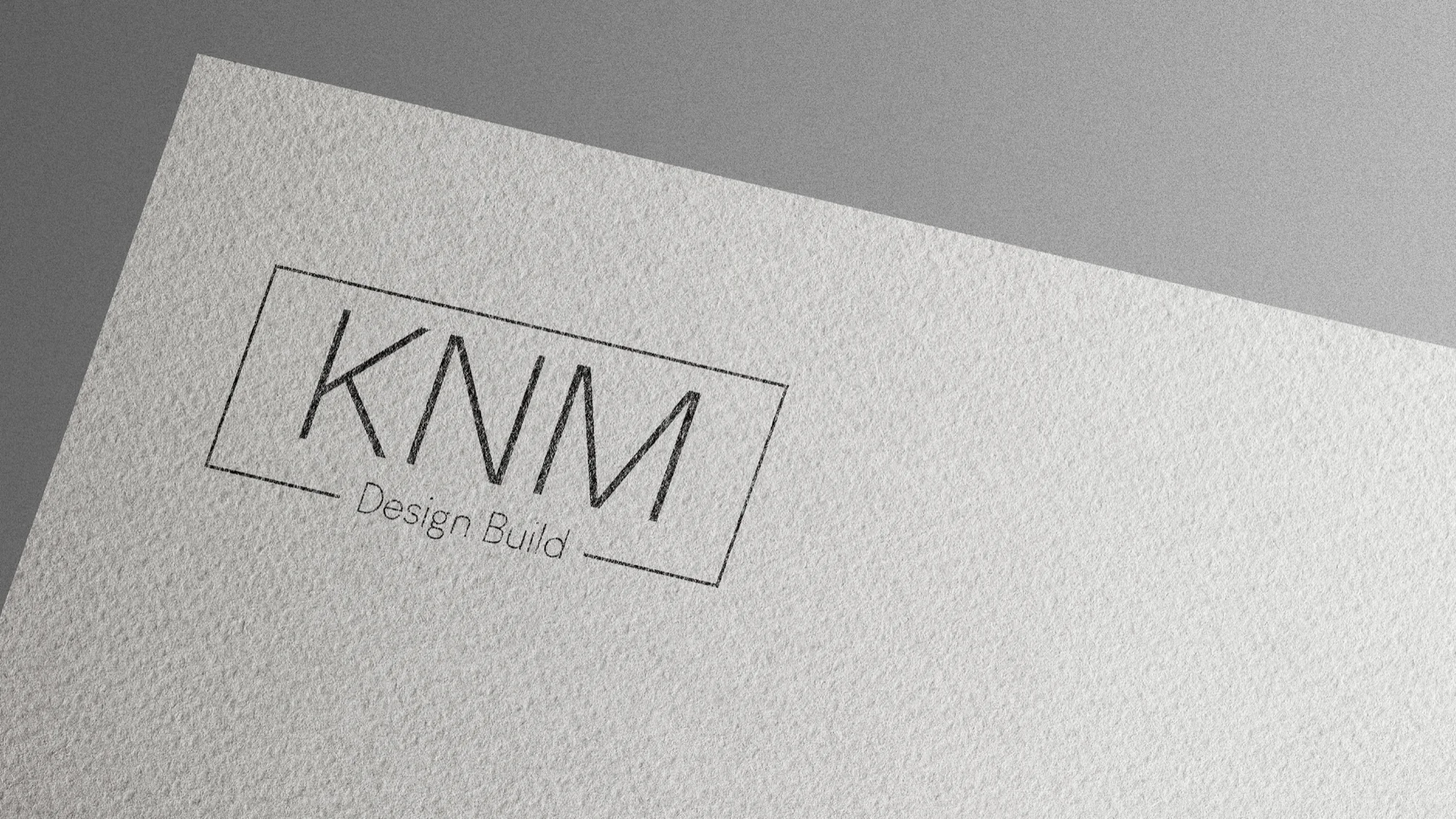 KNM Design Build identity applied to textured stationery