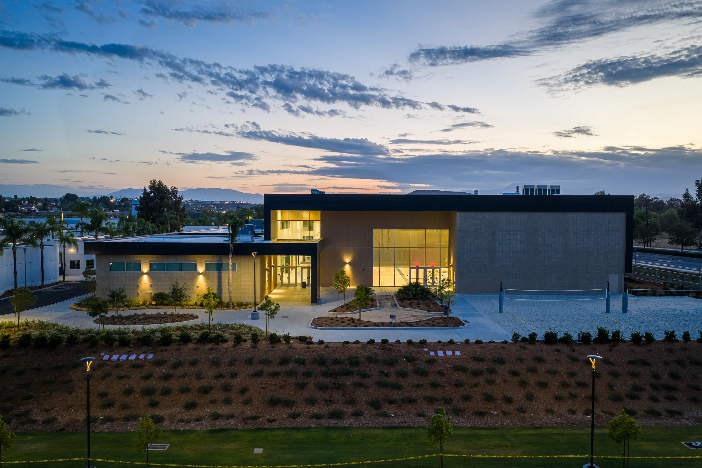 Chaparral High School auxiliary gym illuminated at blue hour for Neff Construction