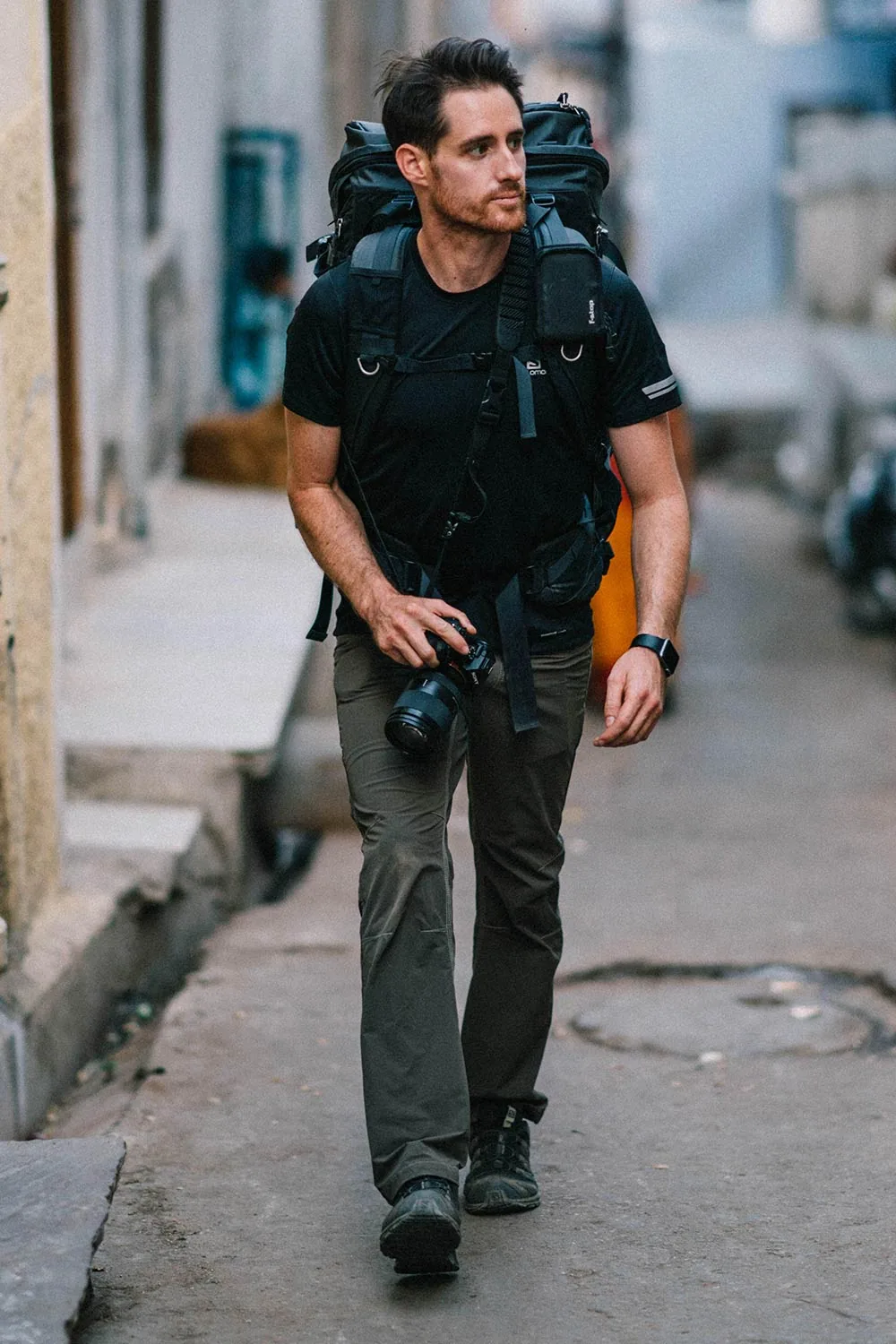 Carlos Mason carrying production equipment on location