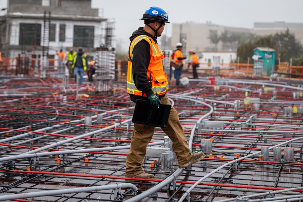AJK field professional walking an active Bundy Project jobsite in 2025