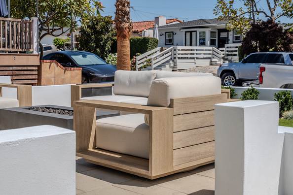 Outdoor lounge seating with a fire feature on the raised front terrace, facing the street.