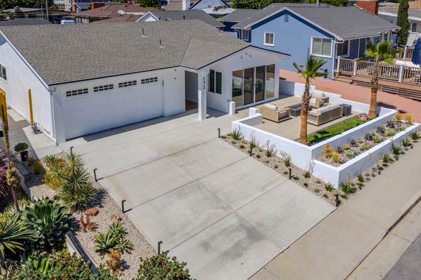 Aerial view straight down over the property showing the driveway, planters and rear yard.