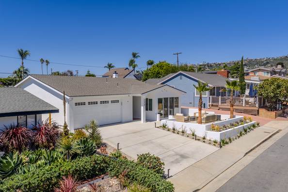 Aerial view of the finished property showing the driveway, planting beds and rear yard.
