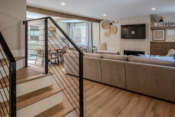 Timber stair treads with a black cable rail opening into the living space.