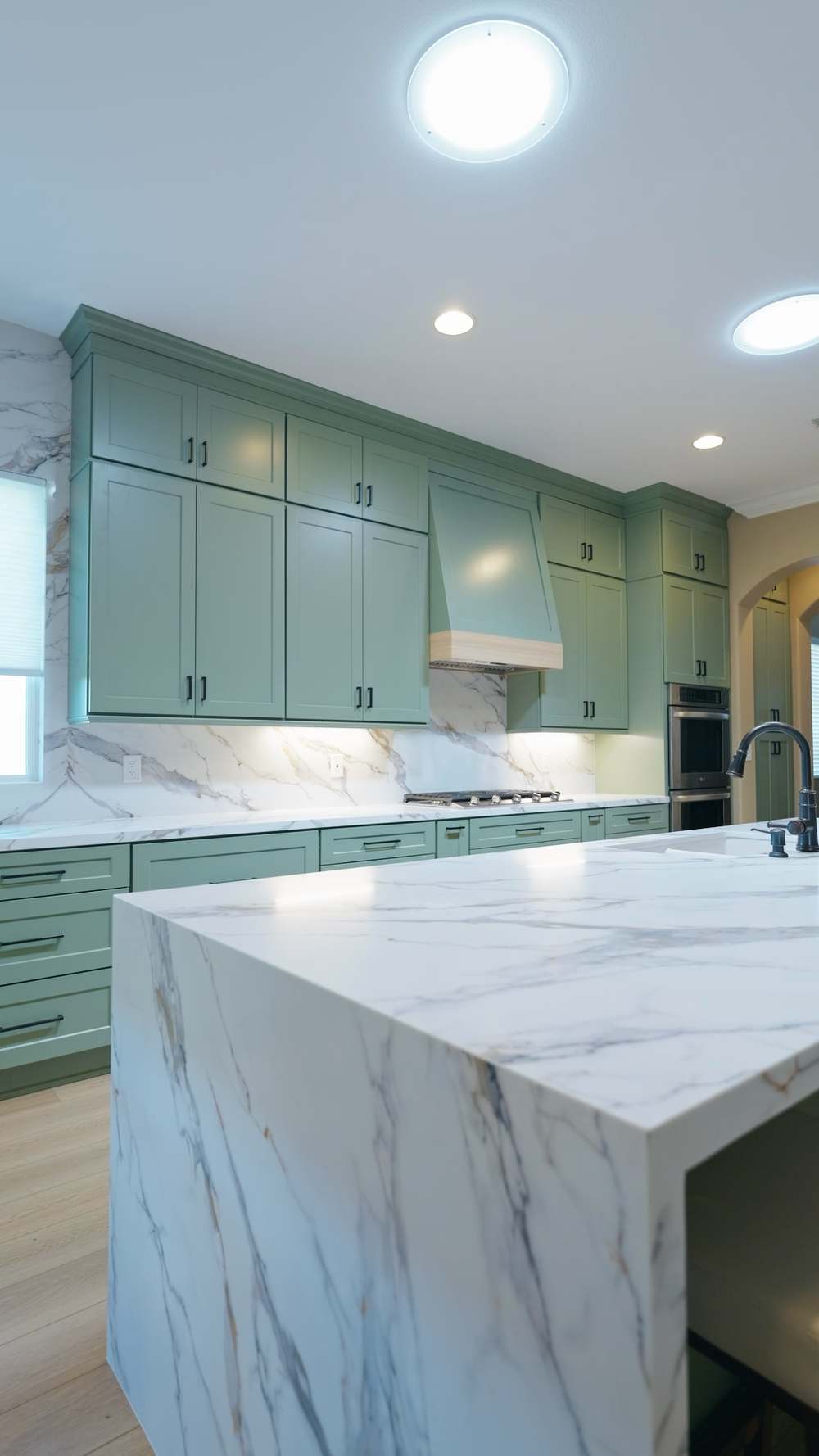 Range wall with custom sage hood and marble backsplash