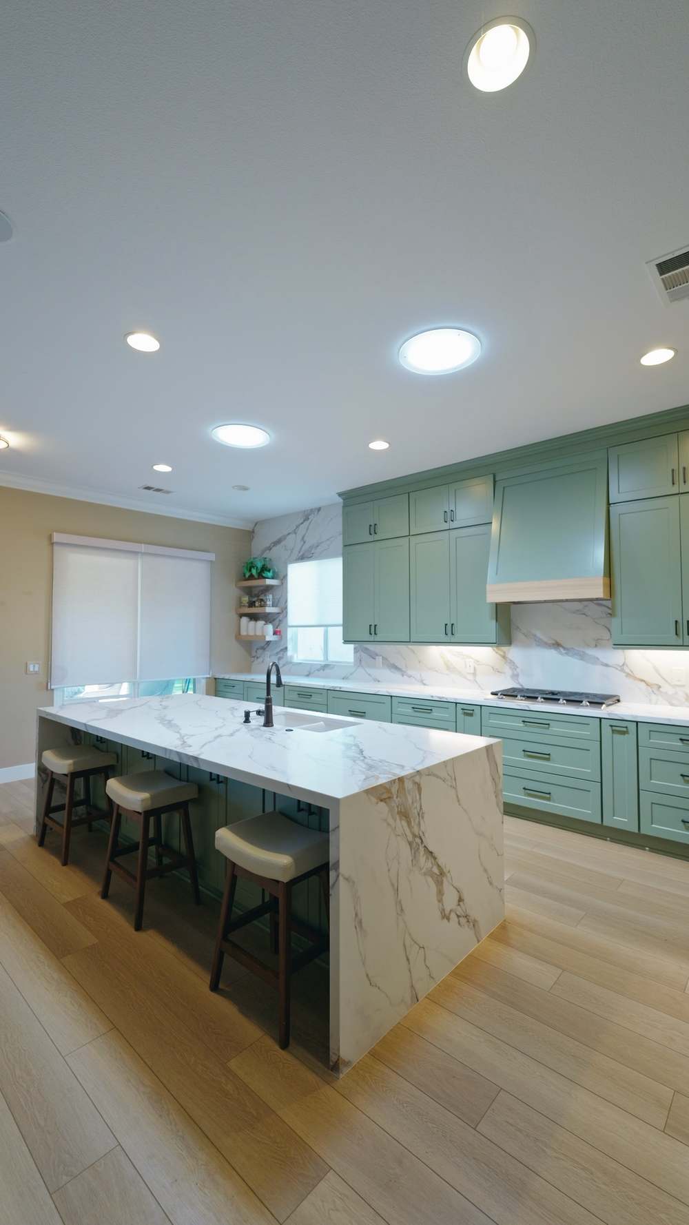 Finished kitchen, wide view with island and stools