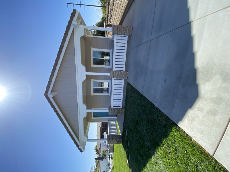 A finished custom ADU with stone, siding and stucco detailing matched to the main house.