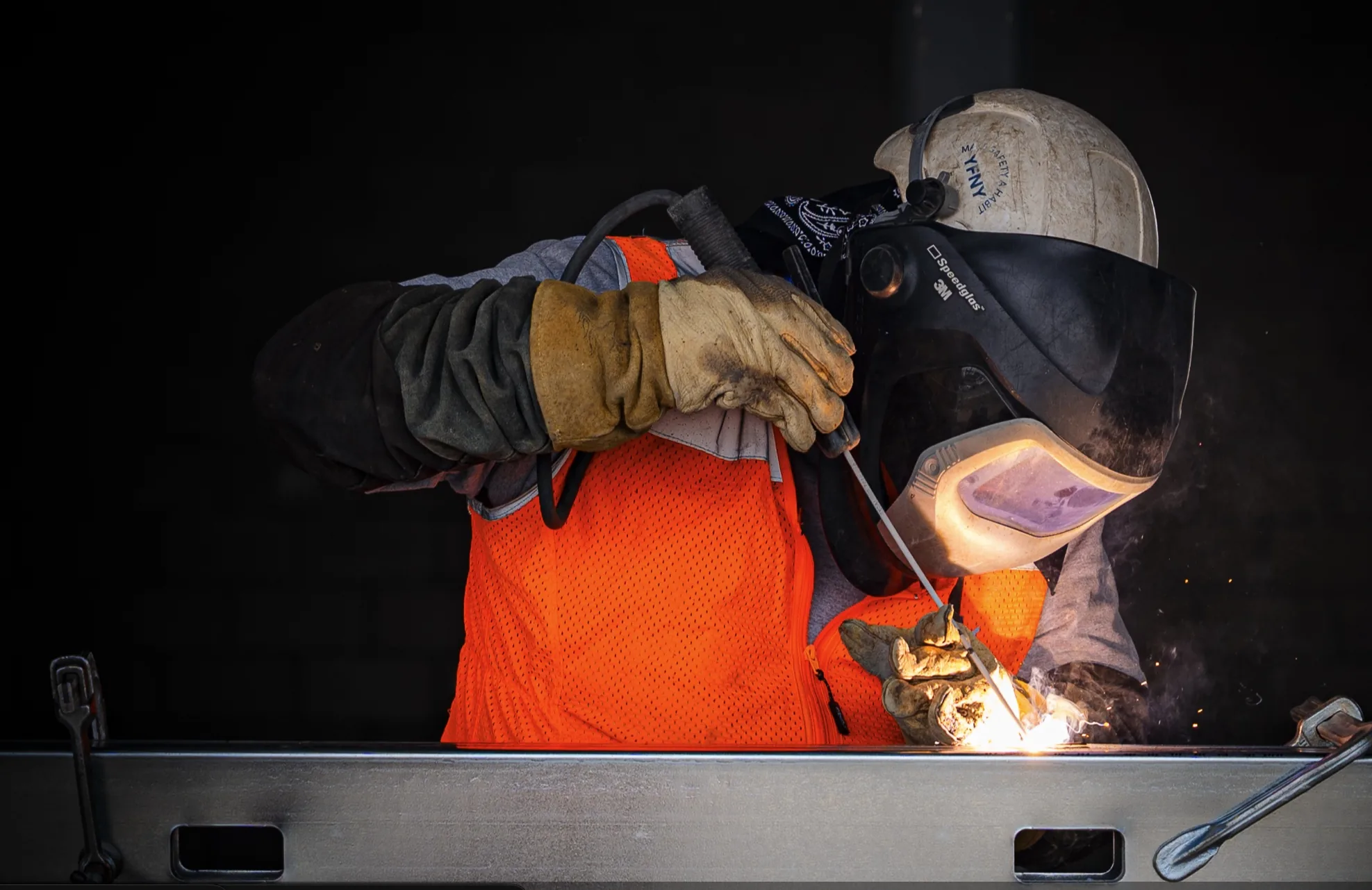 Welder completing field work photographed by Fox & Brand