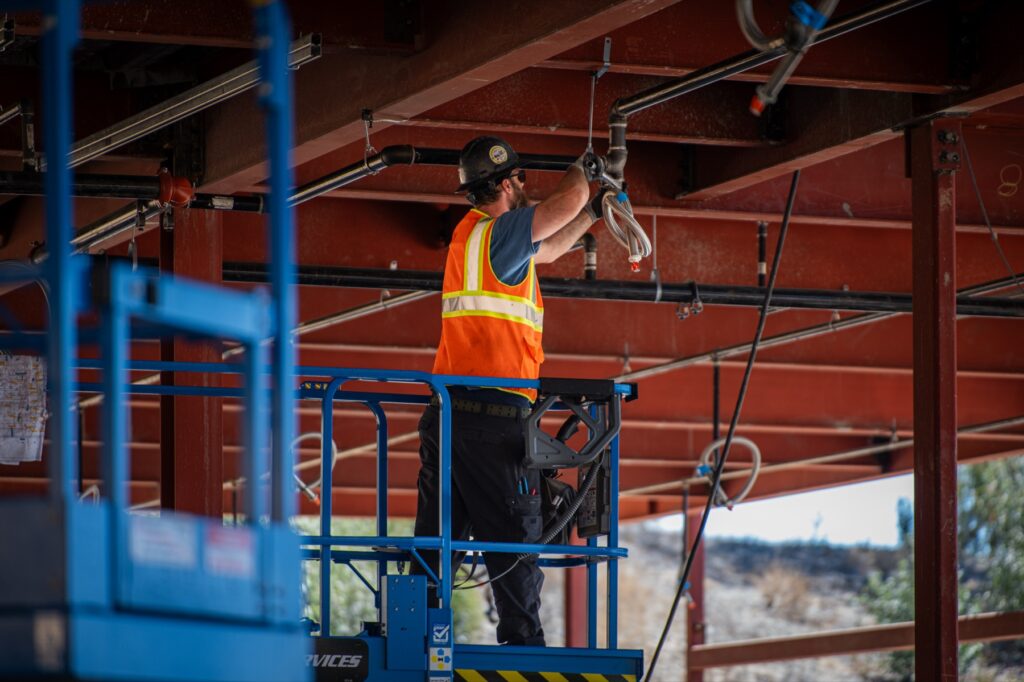 Pro-Craft craft worker completing overhead installation at Crafton Hills College in 2026