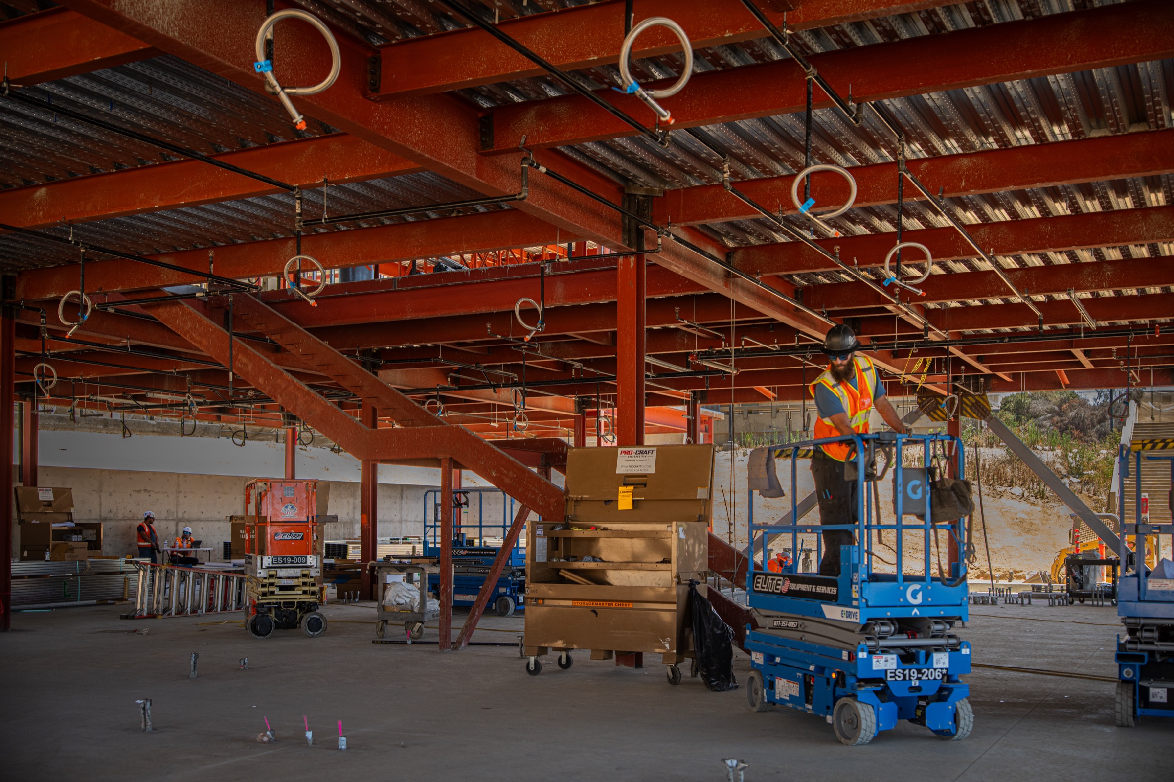 Pro-Craft craft worker installing overhead piping at Crafton Hills College